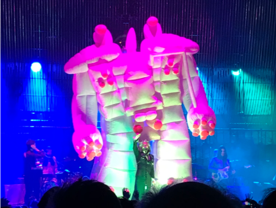 Wayne Coyne of the Flaming Lips on stage at Brixton Academy stood in front of an 18ft tall inflatable robot